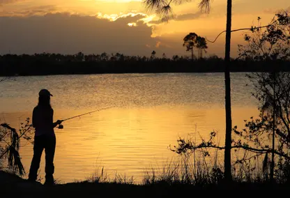 woman fishing at sunset